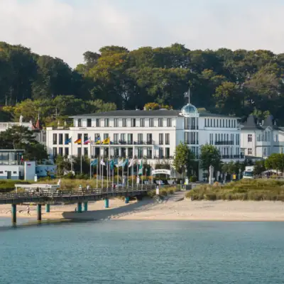 Ceres am Meer Ein Gebäude mit Fahnen und eine Brücke über Wasser.